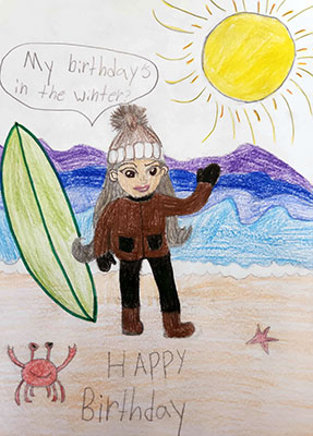 Illustration of a woman in a beanie on the beach. She is saying My birthday’s in the Winter. The Sun is in the sky and a crab is standing next to her on the beach.