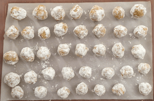 a tray of finished moon cookies sits on a tabletop.
