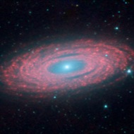 NGC 2841: This Spitzer infrared image of spiral galaxy NGC 2841 shows dust and gas (red in the image) invisible to our eyes or to ordinary telescopes.