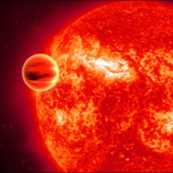 Transit: Artwork of an extrasolar planet as viewed in infrared as it passes in front of its star. The Spitzer Space Telescope detected water vapor in the planet's atmosphere.