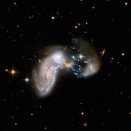 Starburst: In this visible light image from the Hubble Space Telescope, a collision of galaxies has triggered the birth of lots of new stars. Called Zw II 96, this untidy heap is called a starburst galaxy.