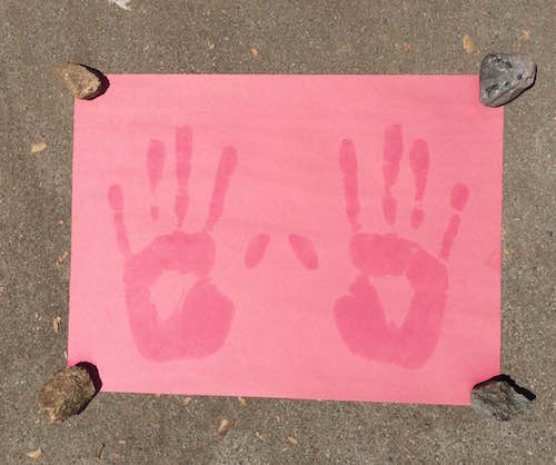 piece of paper with sunscreen hand prints
